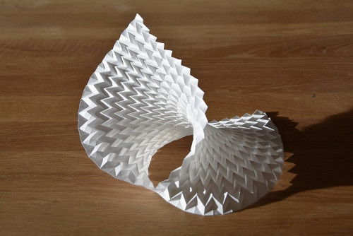 A white paper folded into a spiral

Description automatically generated with medium confidence